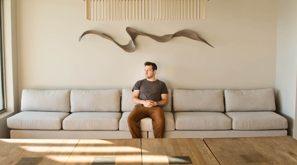 Louw Roets wall sculpture featured in a lounge setting. Louw Roets furniture and decor is available through Sarza store in Rye, New York.