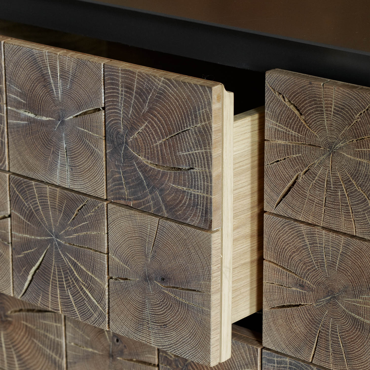 Instomi Metal Side Board by Meyer Von Wielligh. This beautiful Side Board celebrates the uniqueness of timber and tells the story of the tree from which it is made. Using a repeat pattern of the pith of the tree with a timber or metal surround, this design reveals the lifeblood of the tree while the end grain allows us to calculate the age.