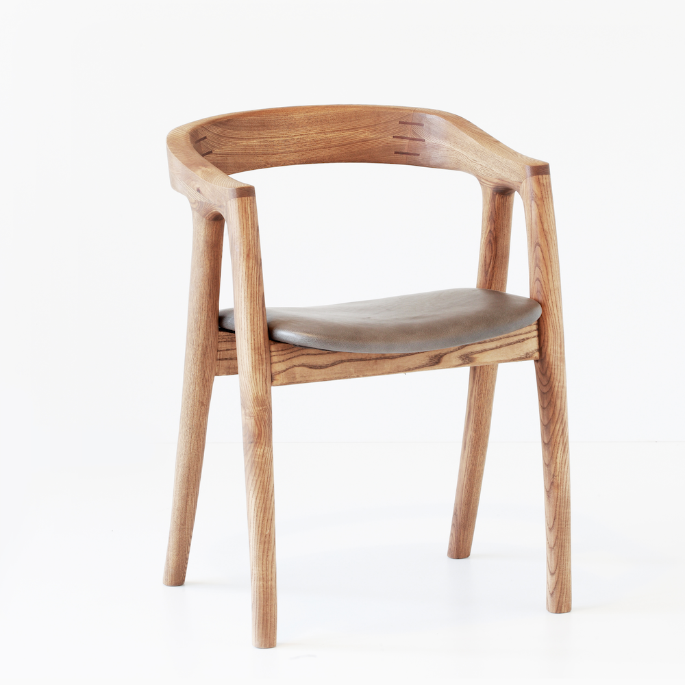 Umthi Dining Chair by Meyer Von Wielligh. The design allows the wood to dictate its natural form. The Umthi Dining Chair is inspired by the organic lines of tree branches.