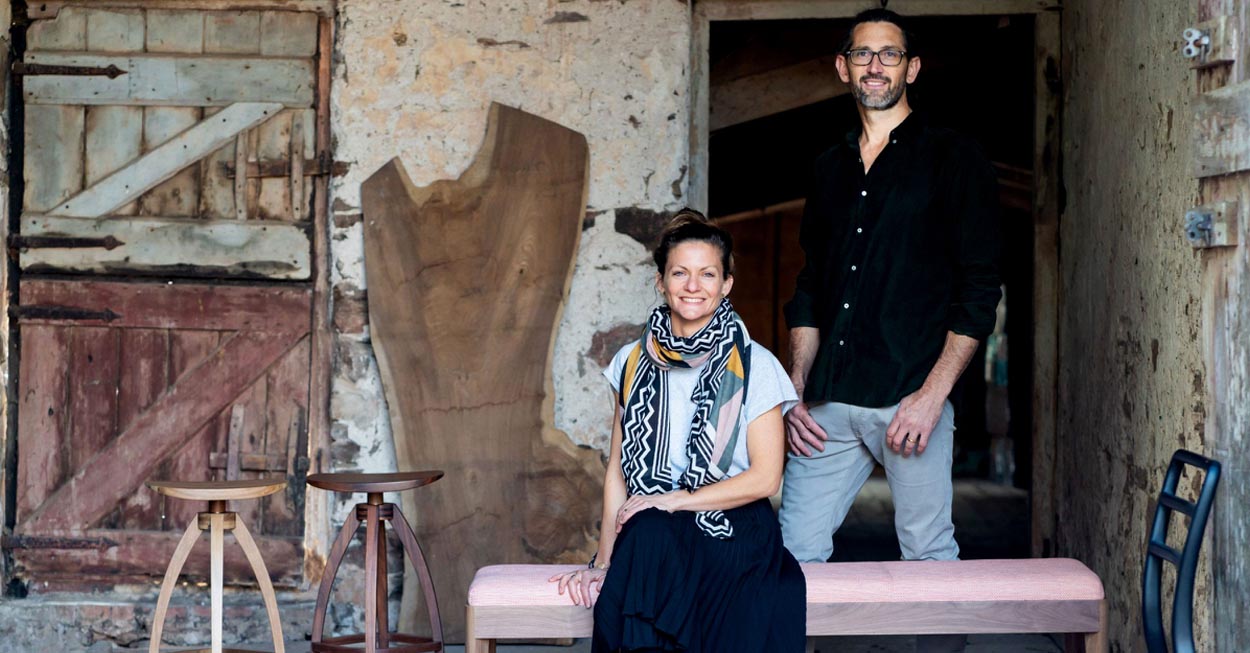 Andrew Dominic, maker of fine wooden furniture, and his wife Susie. Andrew Dominic furniture is handmade and available at Sarza store home goods and furniture store.