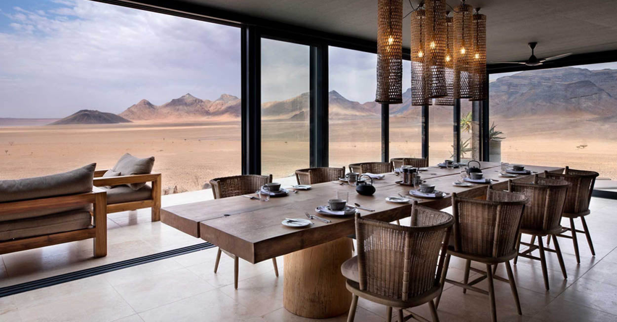 An Umdabu live edge wooden table in a desert setting. Umdabu live edge tables are handmade and unique and available at Sarza store home goods and furniture store.