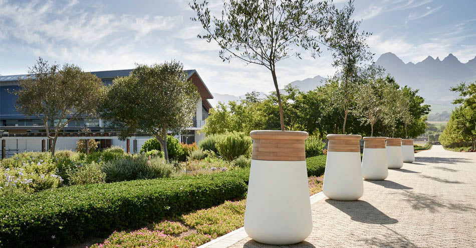 Indigenus planters styled in a landscaped outdoor setting. Indigenus indoor and outdoor planters are available at Sarza home goods, furniture & décor store in Rye