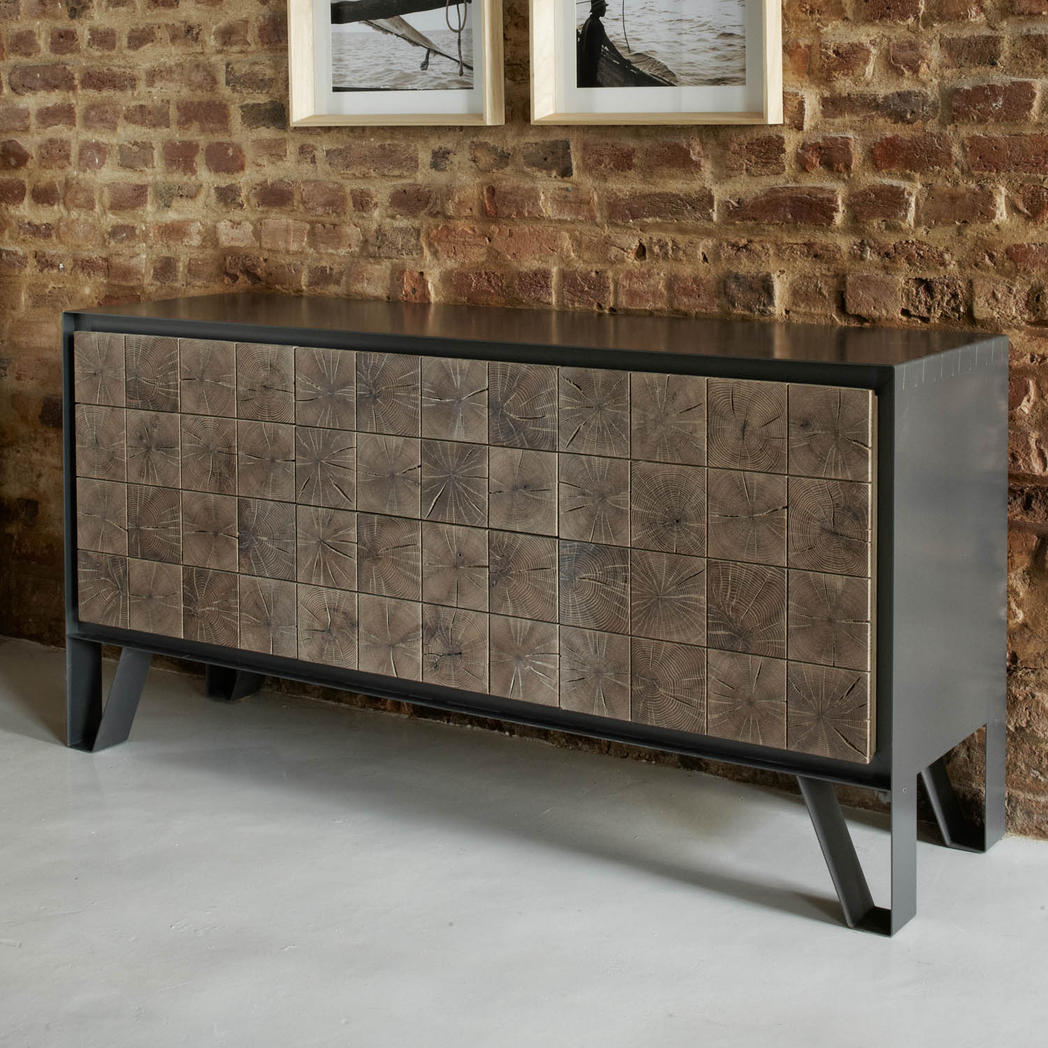 Instomi Metal Side Board by Meyer Von Wielligh. This beautiful Side Board celebrates the uniqueness of timber and tells the story of the tree from which it is made. Using a repeat pattern of the pith of the tree with a timber or metal surround, this design reveals the lifeblood of the tree while the end grain allows us to calculate the age. 