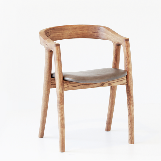 Umthi Dining Chair by Meyer Von Wielligh. The design allows the wood to dictate its natural form. The Umthi Dining Chair is inspired by the organic lines of tree branches.