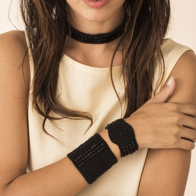 WIDE LEATHER CUFF -  JEWELRY BY SIDAI DESIGNS. An intricately beaded leather bracelet from our Sipolio collection. This collection shares the journey of boyhood to warriorhood of a young Maasai male, who wears black and adorns himself with white beaded jewelry and detailed face markings.
